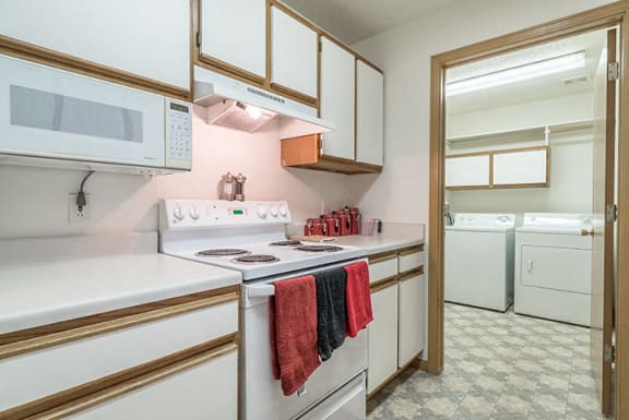 Kitchen with lots of storage and attached laundry room at The Northbrook Apartment Homes, Lincoln, NE