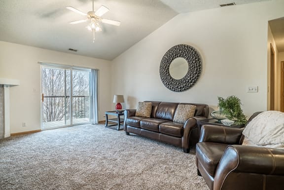 Large roomy living room with balcony at The Northbrook Apartment Homes, Lincoln, NE