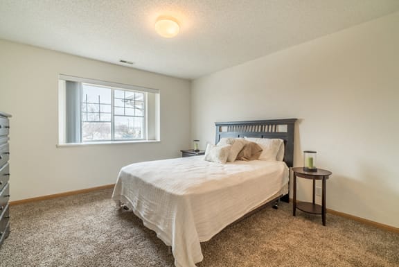Spacious bedroom with large window for natural lighting at Northbrook Apartments