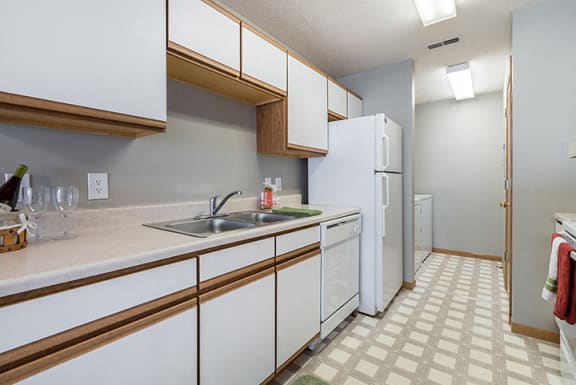 kitchen with laundry room off to side at Williamsburg Park Apartments in Lincoln NE