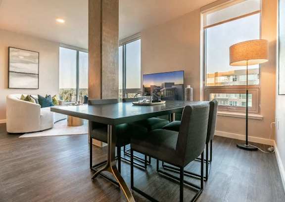 A modern dining room with a large table and chairs.
