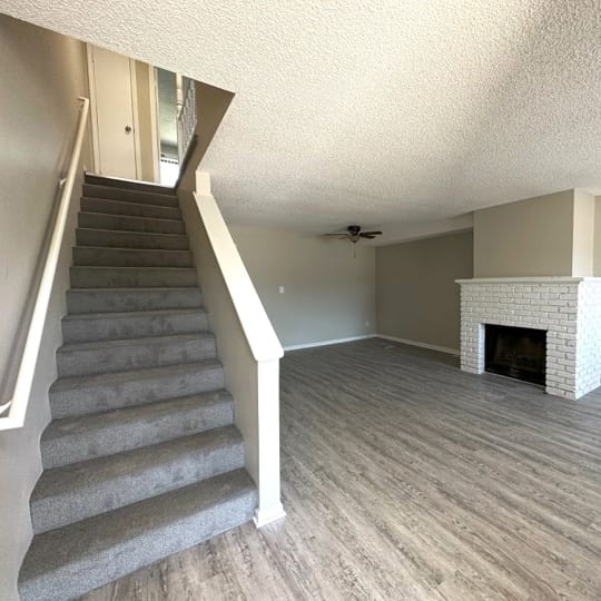 an empty living room with a fireplace