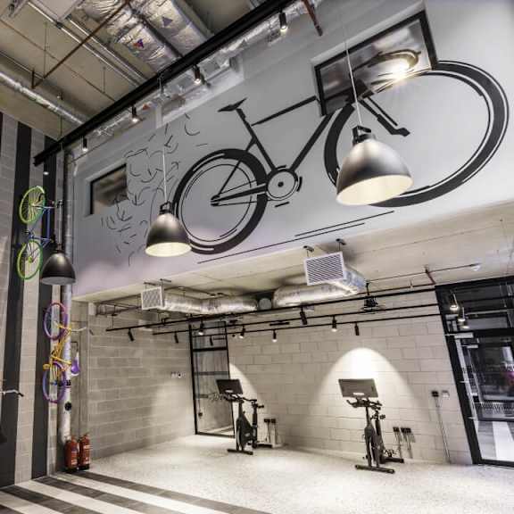A gym with a bike on the wall at Beton Apartments, Wembley, HA9 0SL