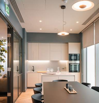 A modern kitchen with a dining table and chairs.