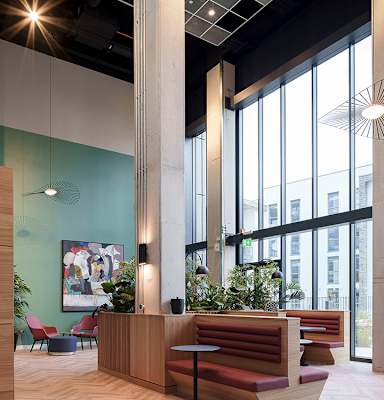 A modern office space with a wooden reception desk and red seating at Cherrywood Apartments, D18 VY3V, DUBLIN 18