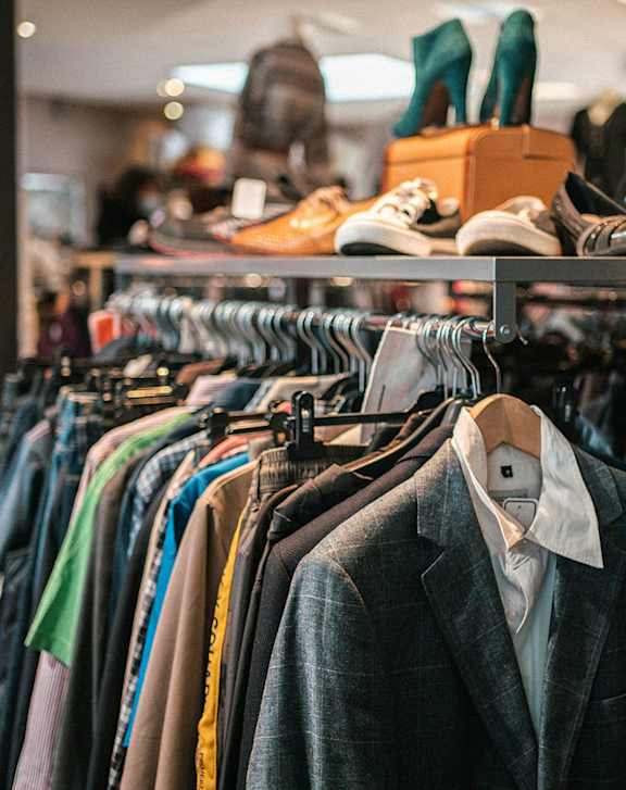 Clothes hanging on a rack in a store.