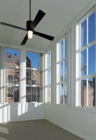 a woman sitting on a chair in a window