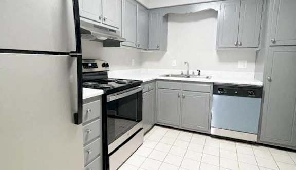 A kitchen with white appliances and white cabinets.