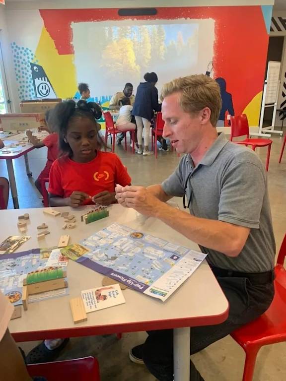 A man and a girl playing a board game.