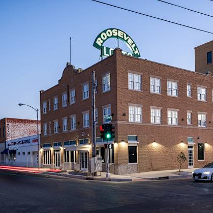 A building with a green sign that says "Roosevelt" on it.