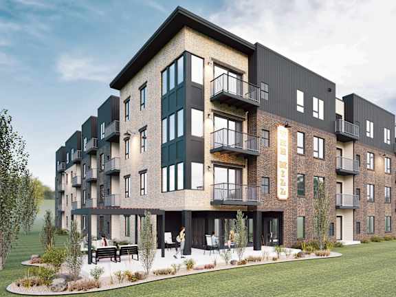 A modern apartment complex with balconies and a landscaped courtyard.