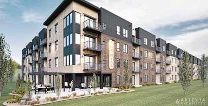 A modern apartment complex with balconies and a landscaped courtyard.