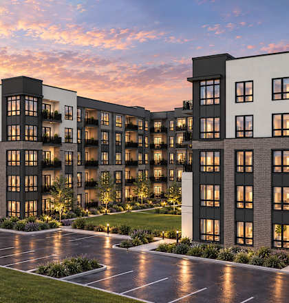 A modern apartment complex with multiple buildings and a parking lot in front.