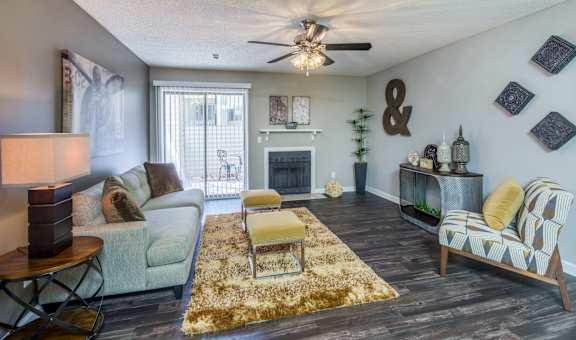 A living room with a fireplace and a couch. at Woodwinds, Aiken, South Carolina
