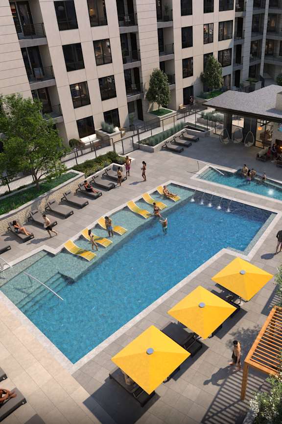 A pool area with a yellow sunbed and a yellow umbrella.