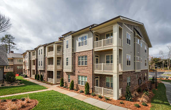 A large apartment building with multiple balconies and windows.