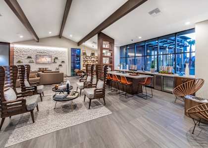 A modern living room with wooden furniture and a stone wall.