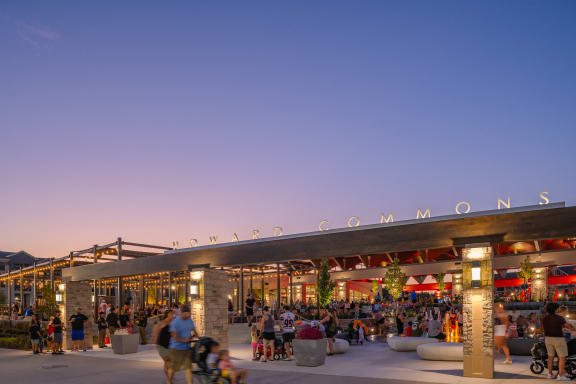 people walking around the commons pavilion at dusk