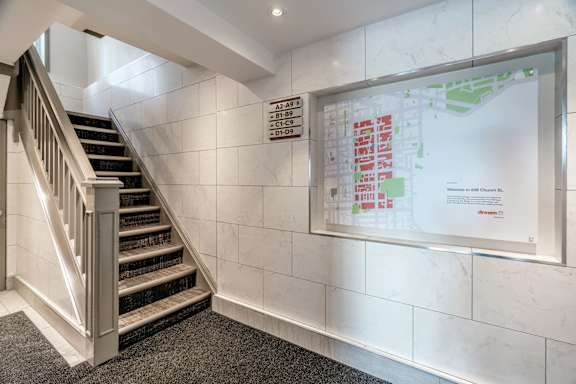 A staircase with a wall-mounted map of a building. at 608 Church Apartments, Toronto, ON, M4Y 2E7
