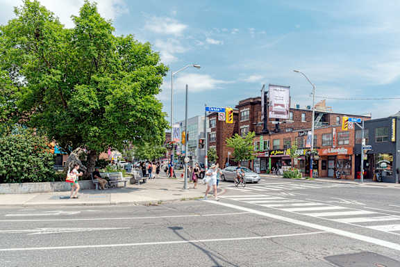 a family walking in the park with their children at 723 Bloor Apartments, Canada