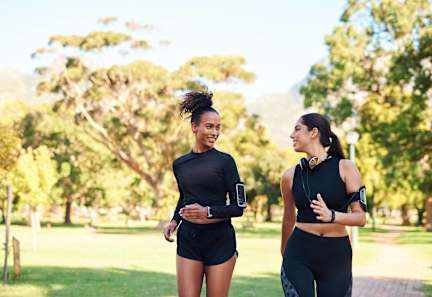 Two women jogging in a park at Aspenridge Apartments,Washington 98683