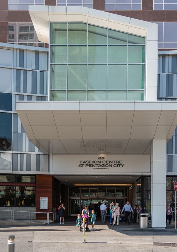 the front of a building with people walking in front of it