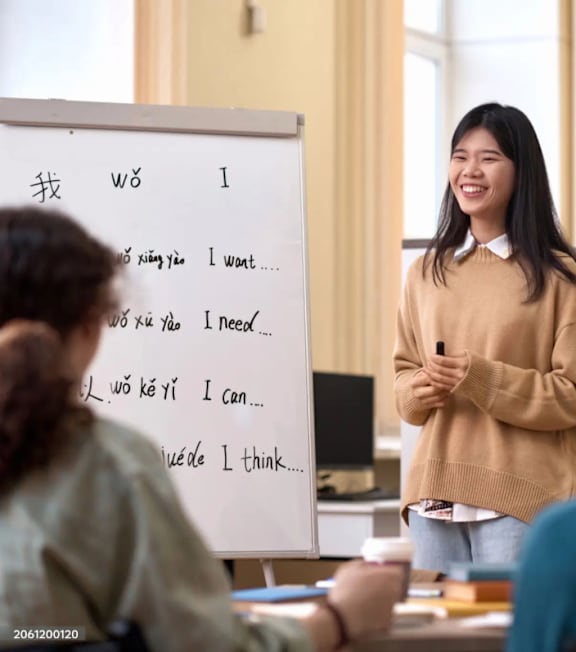 A girl in a helmet is riding a bicycle on a road.