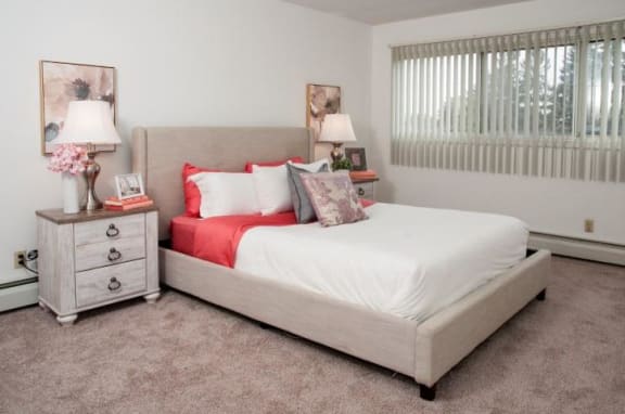 Large Master Bedroom with Wide Full Wall Windows in Bloomington Apartment