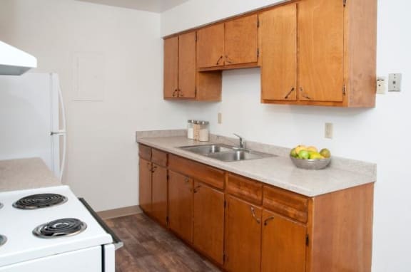 8920 Wentworth Apartment Kitchen with Wooden Cabinetry and White Appliances