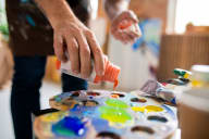 a person applying paint to a painting