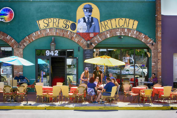 people sitting at tables outside of a restaurant at Promontory, Tucson
