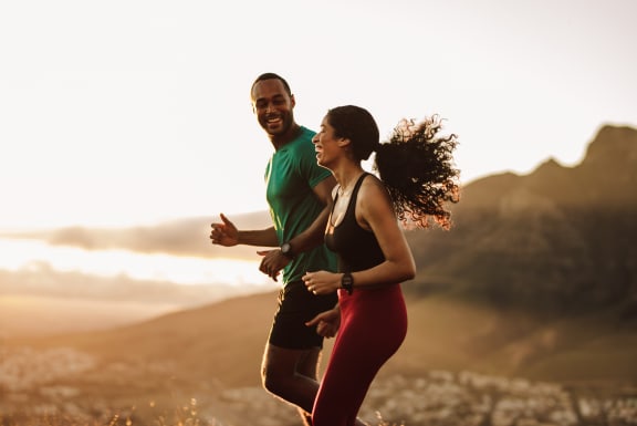 a man and a woman running on a beach at Anacapa Canyon, Camarillo, 93012