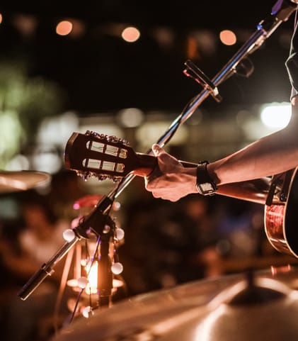 a musician playing drums at a concert at night at The Lodge at Lakeline Village, Cedar Park, 78613