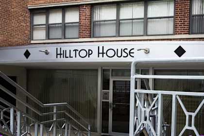 a building with a sign that reads hilltop house