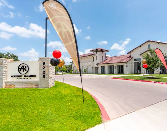 a view of the front of the building with the sign in the foreground and the building in