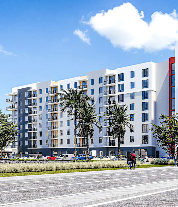 A modern multi-story building with a red car parked in front.