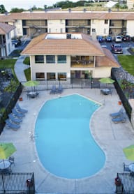 A large swimming pool in front of a building.