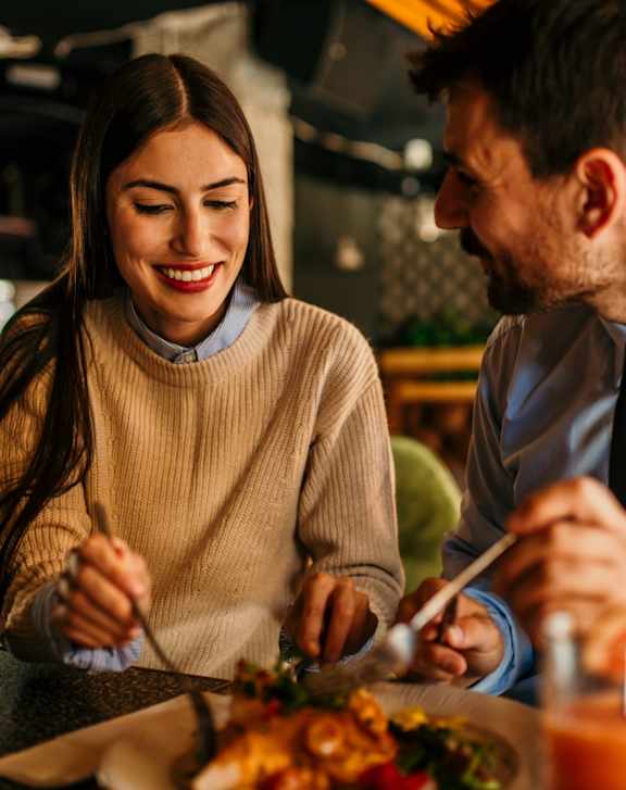 A man and a woman are enjoying a meal together.