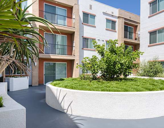 a large white planter in front of an apartment building