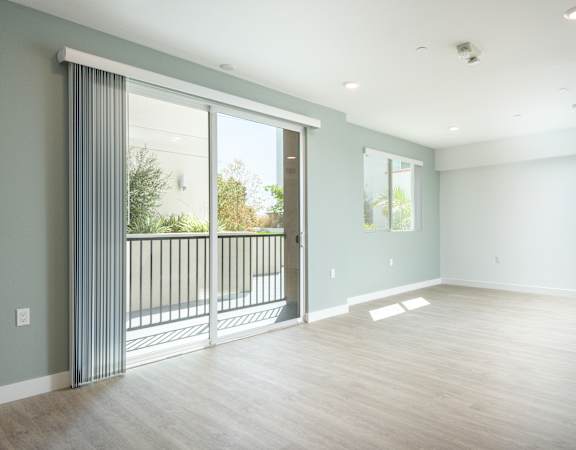 a living room with a large window and a balcony