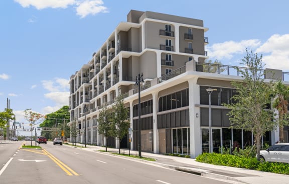 a large apartment building on the corner of a city street