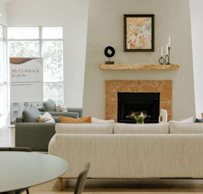 a living room with a white couch and a fireplace