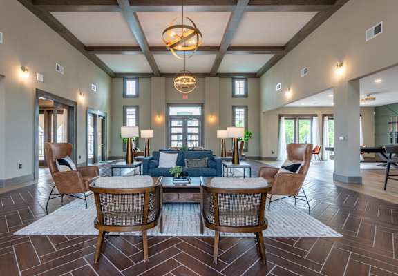 a living room with a couch and chairs and a table