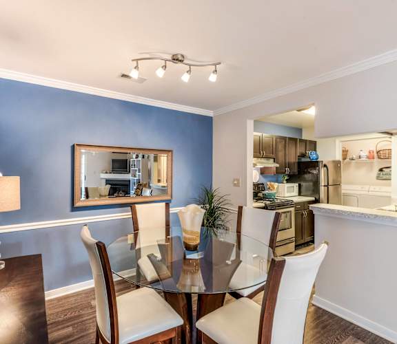 a dining room with a glass table and chairs at Brittany Commons Apartments, Spotsylvania, VA, 22553