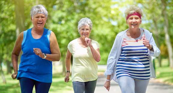 a group of women walking in the park