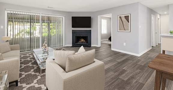 a living room with a fireplace and a large window