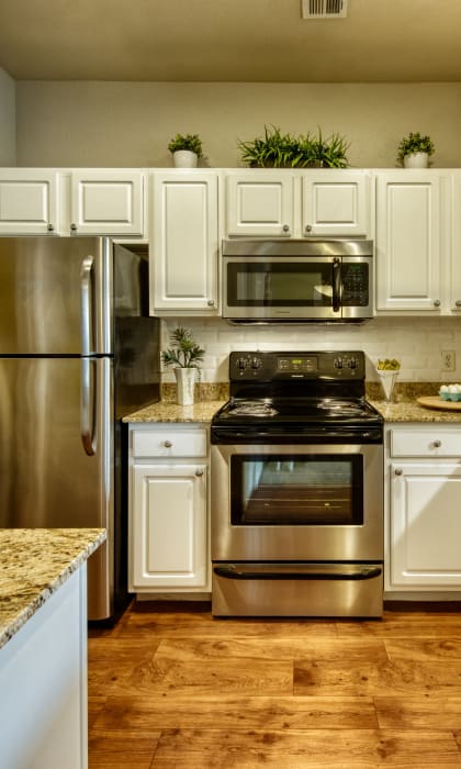 a kitchen with stainless steel appliances and white cabinets