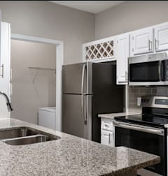 A kitchen with a granite countertop and stainless steel appliances.at Greys Harbor at Lake Norman, Huntersville, 28078