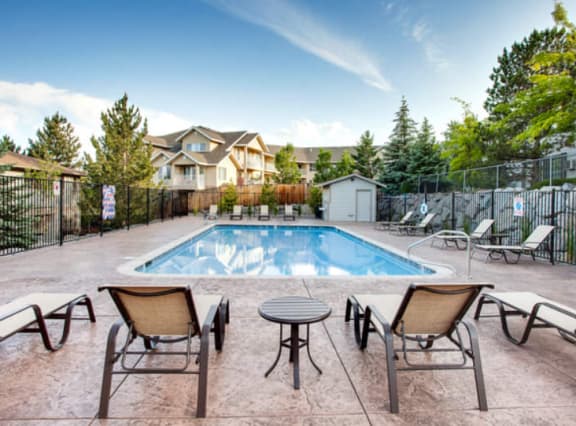 a swimming pool with patio furniture and chairs around it at ALTITUDE BY VINTAGE, Reno, NV