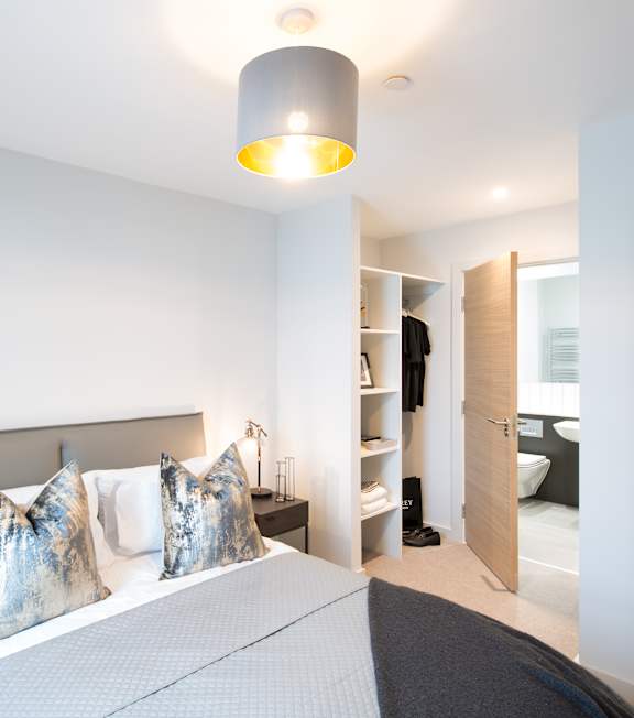 a living room with a couch and a table at The Foundry Apartments, Bordon, GU35 9FE